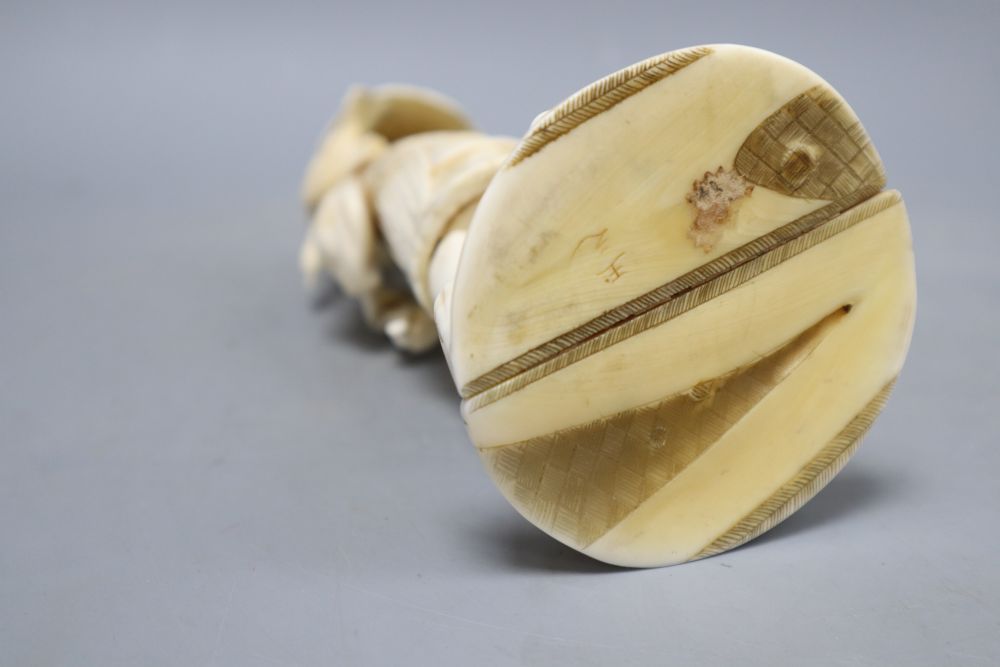 A Japanese sectional walrus ivory figure of a cormorant fisherman, character marks to base, height 23cm